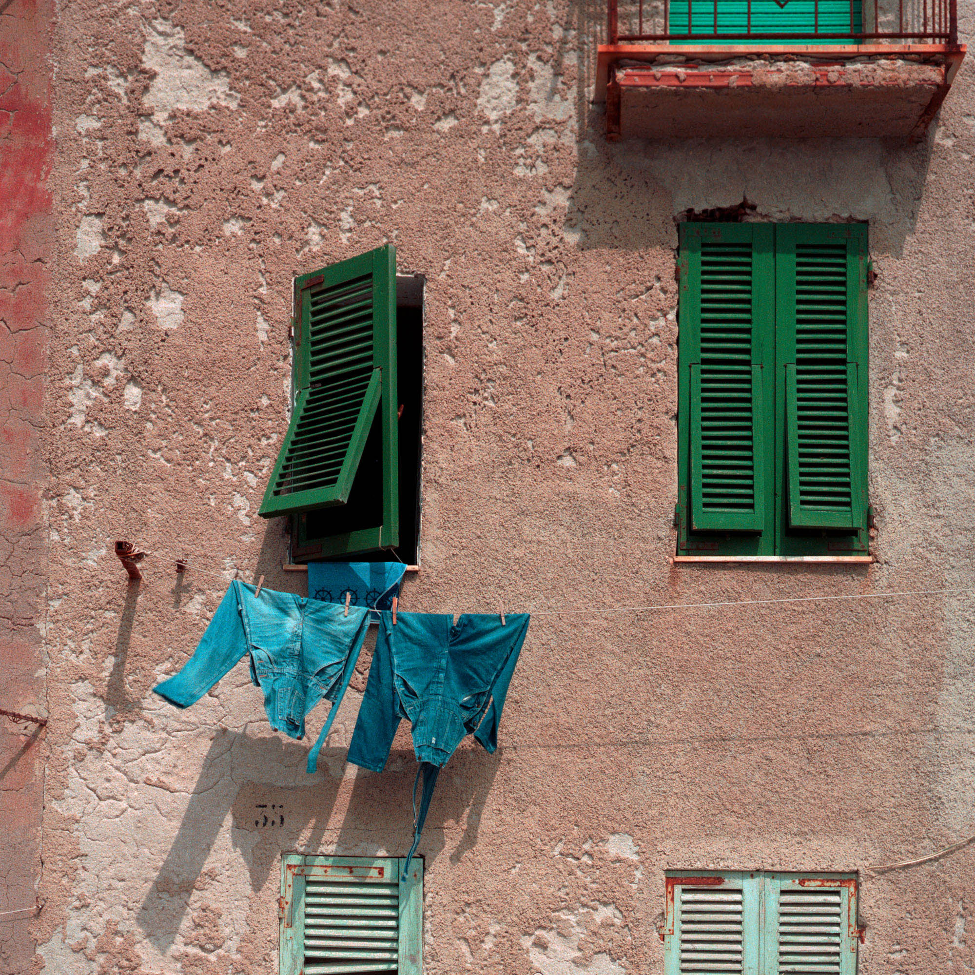 jeans overalls blowing wall Italy Alghero